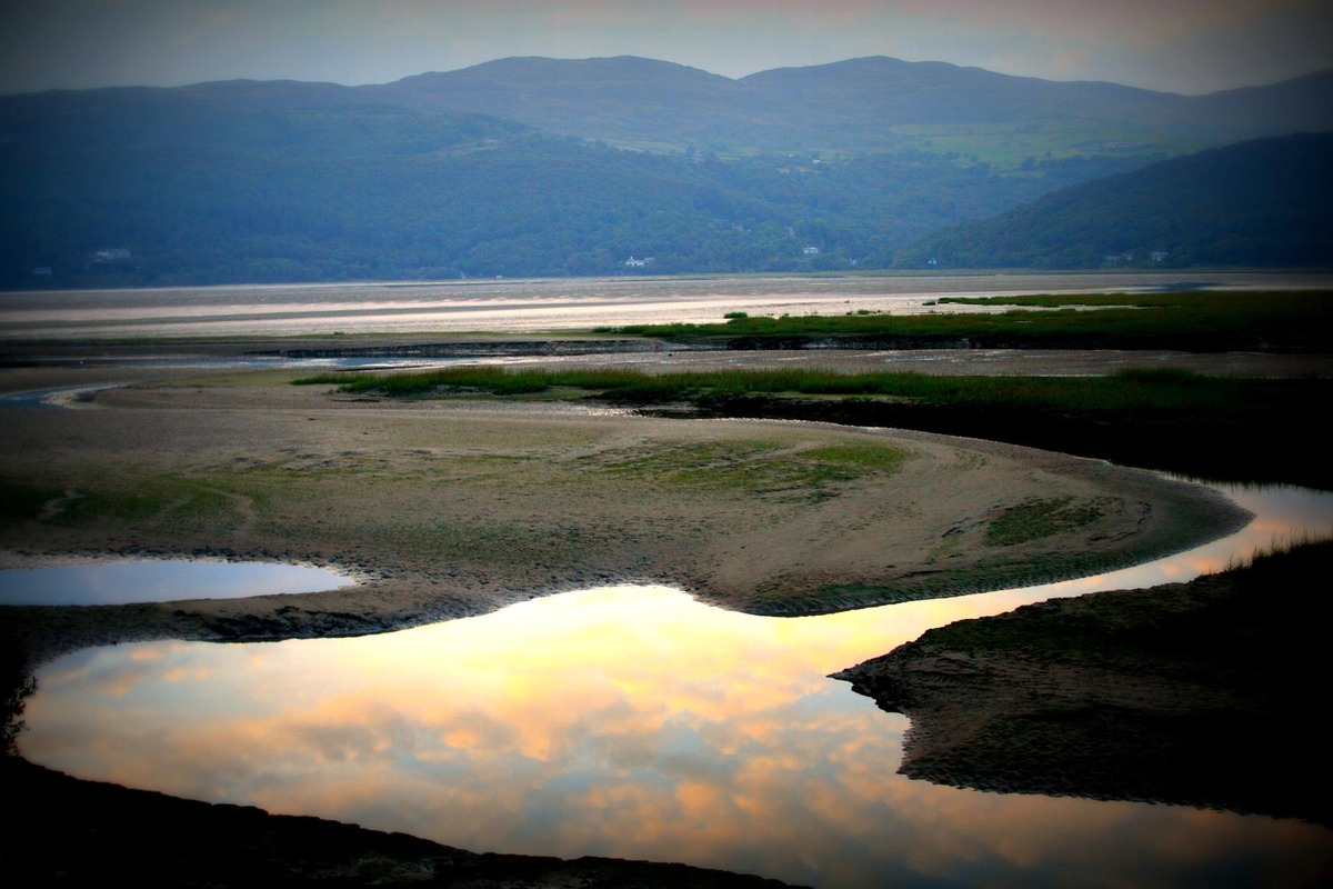 A peaceful Welsh estuary beneath the hills at sunset
